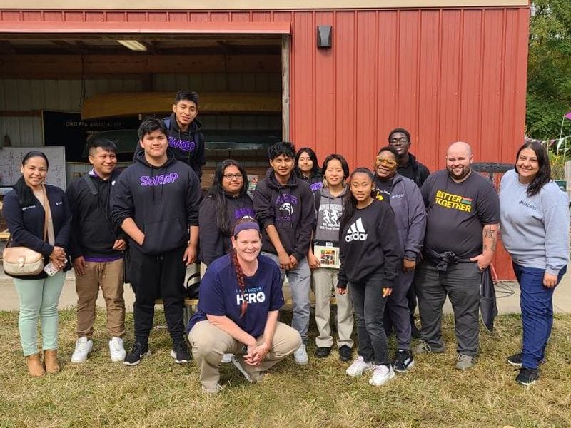 Black Employee Network group gathers for a photo in front of a barn